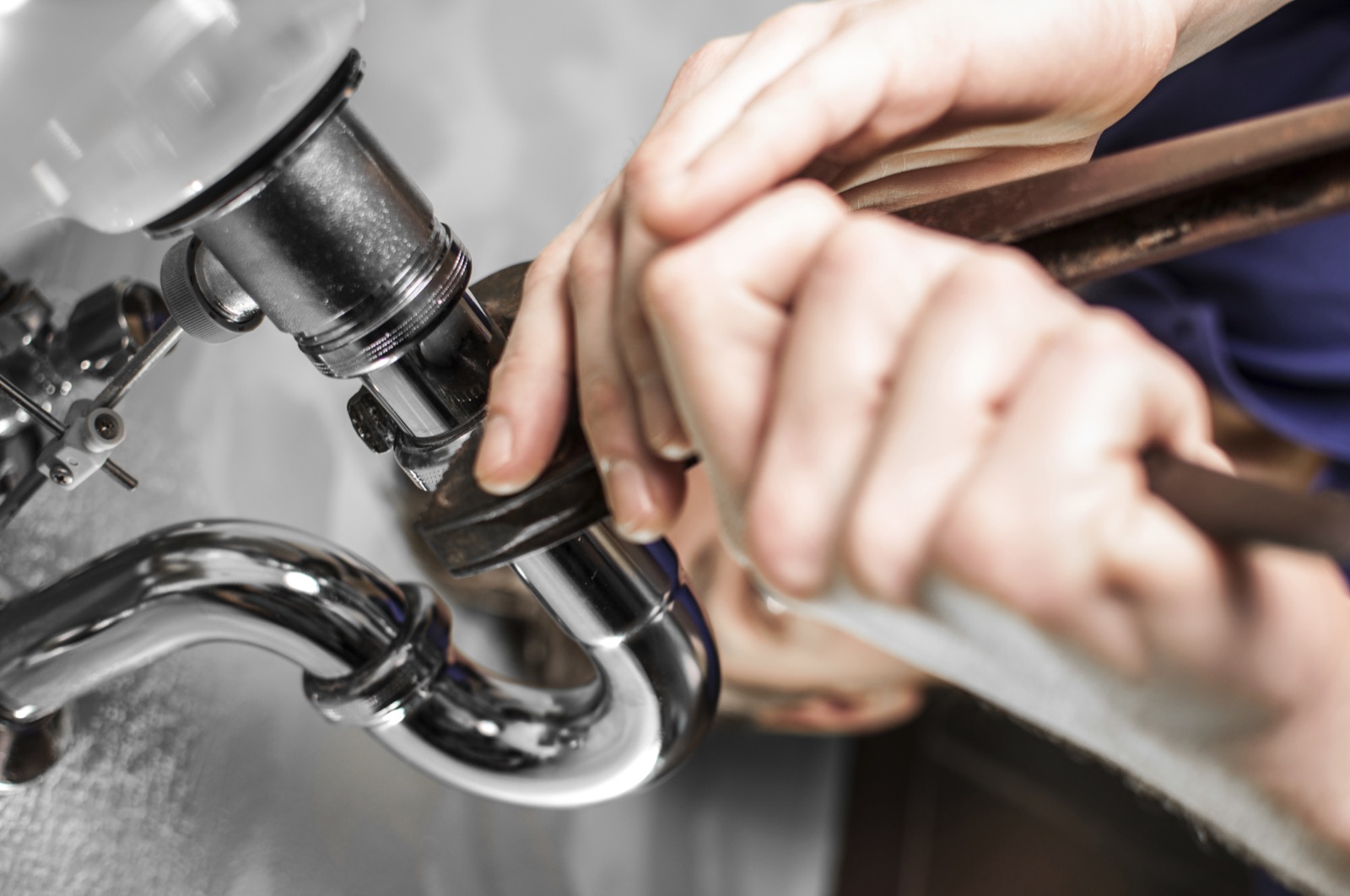Plumber repairing pipework, image reused from the original Forefront Plumbing Services website
